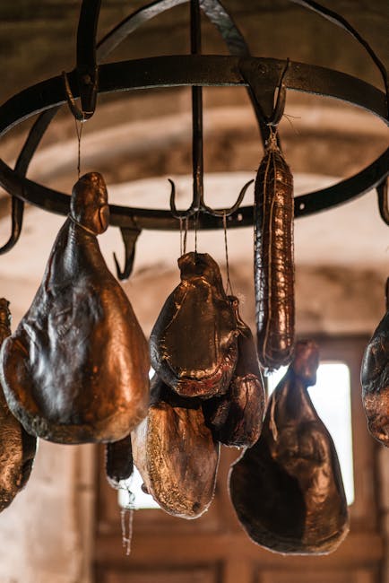 Jambons et saucissons artisanaux suspendus dans le séchoir de La Belle Corne à Aussonne